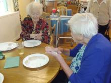 Resident at The Dynes making a harvest loaf Resident at The Dynes making a harvest loaf